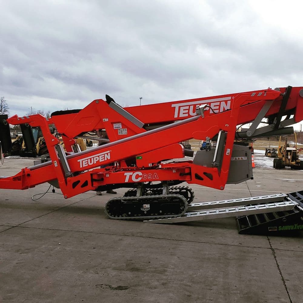 Teupen TC 69 A tracked aerial lift in industrial setting, showcasing its extended platform.